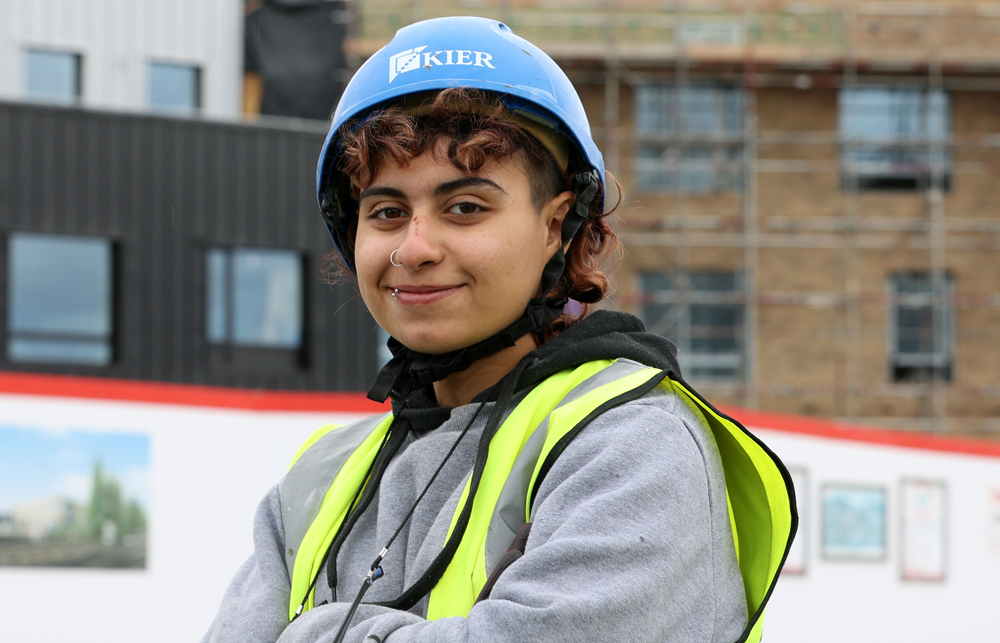 Female JGW+ construction learner, Faith working on a building site