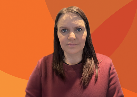 Headshot of ALS, BSL learner Nicola on an orange background