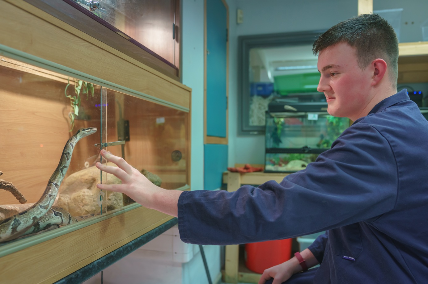 Learner next to snake enclosure