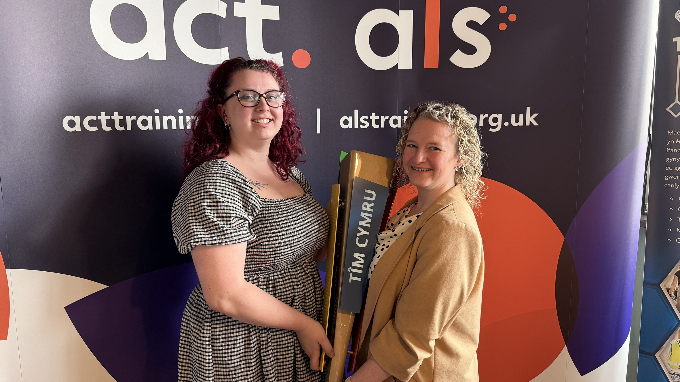 Learners, Lauren and Maddie, holding the WorldSkills torch