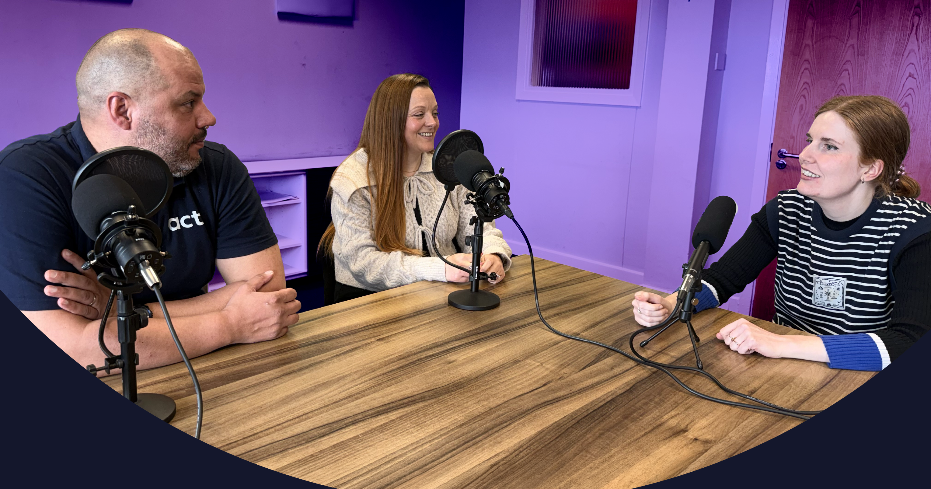 Leon, Ros and Millie around a table, talking into microphones