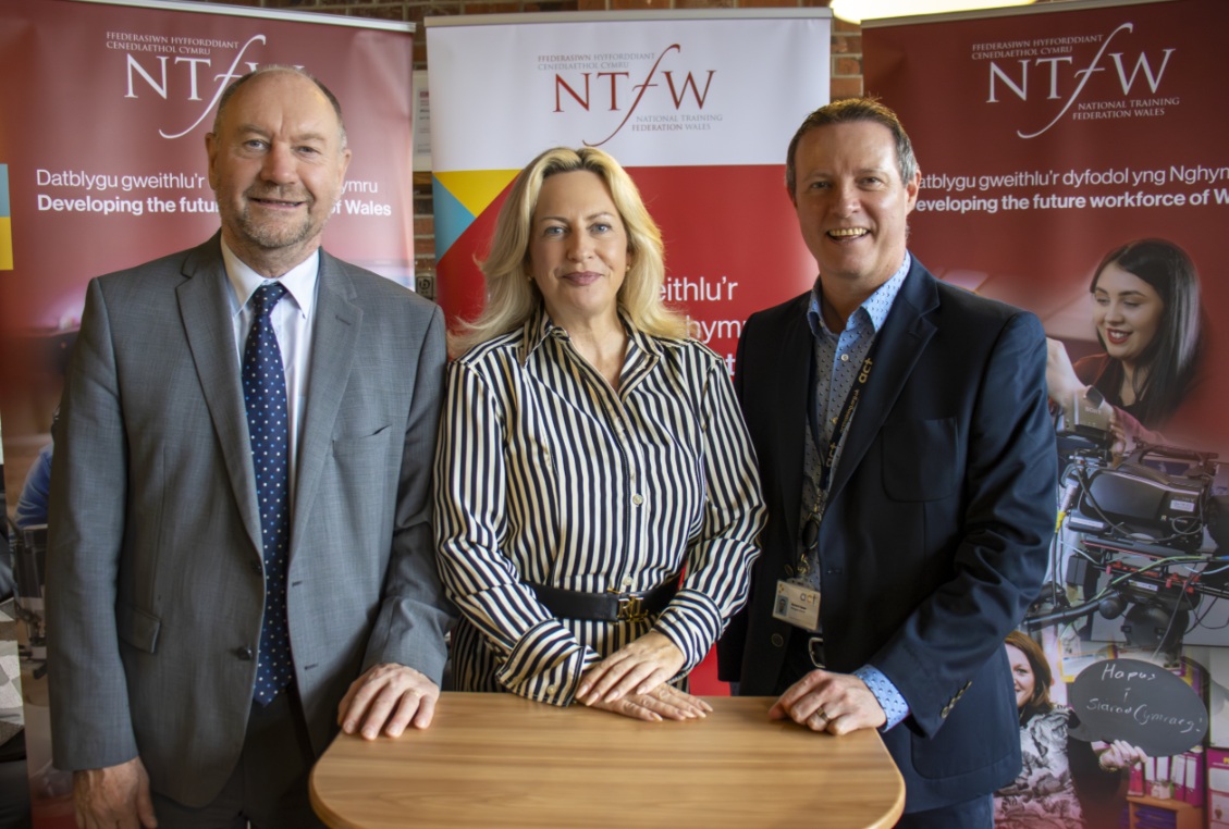 Cefin Campbell, Lisa Mytton and Richard Spear standing in front of an NTFW banner