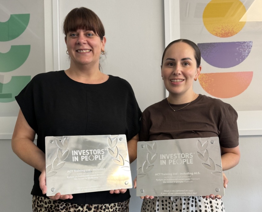 Rebecca and Beth holding the Investors in People plaques